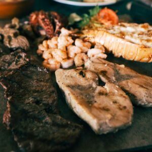 A mouthwatering platter featuring grilled meats and seafood, perfect for a gourmet meal.
