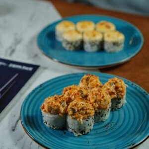 Sushi rolls elegantly plated on a marble table, showcasing gourmet indulgence.